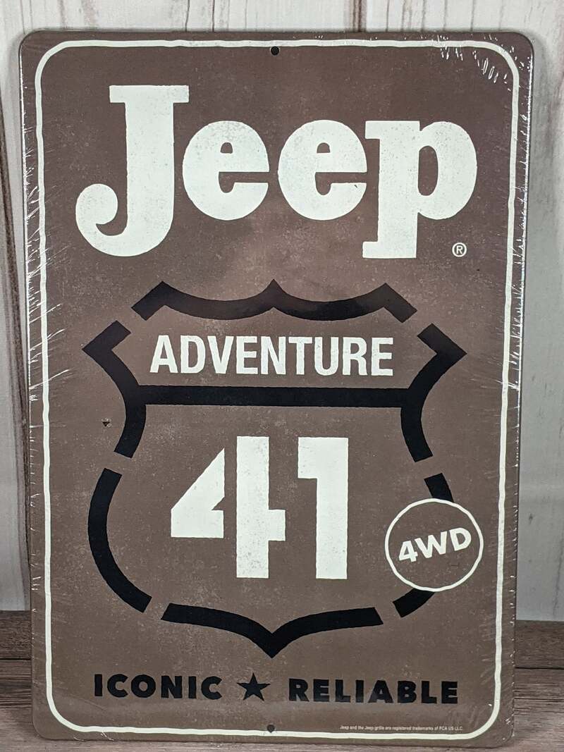 A gray metal wall sign with the words Jeep Adventure 41.