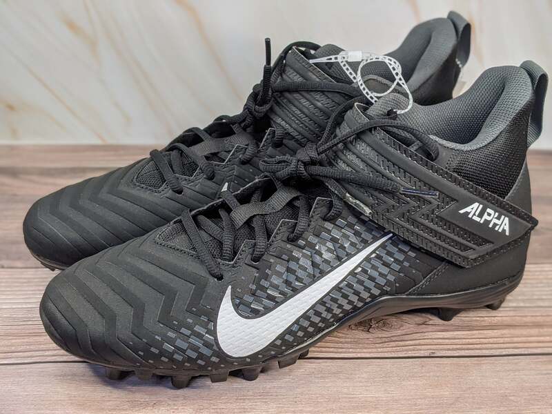 Men's Nike black football cleats with a white swoosh.