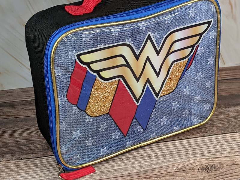 Red, blue and gold lunch bag with the Wonder Woman logo on the front.