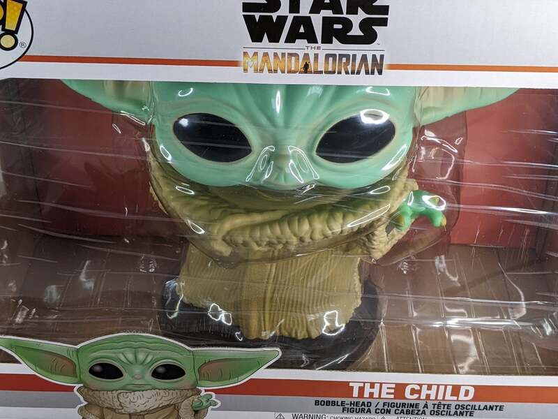 A giant bobble head of The Child by Funko Pop! from Star Wars Mandalorian.
