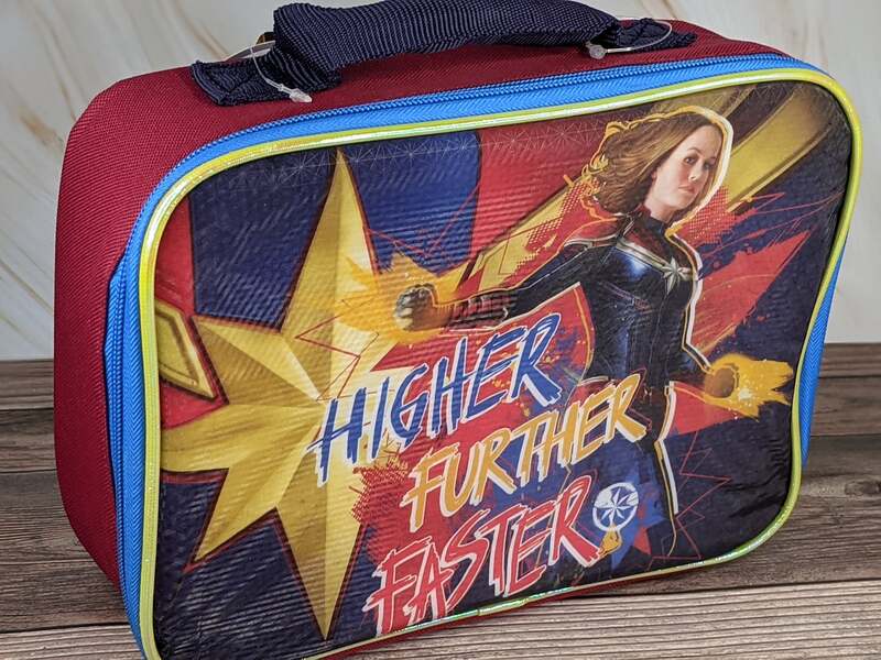 A red, blue and yellow lunch bag with an image of Captain Marvel on the front.