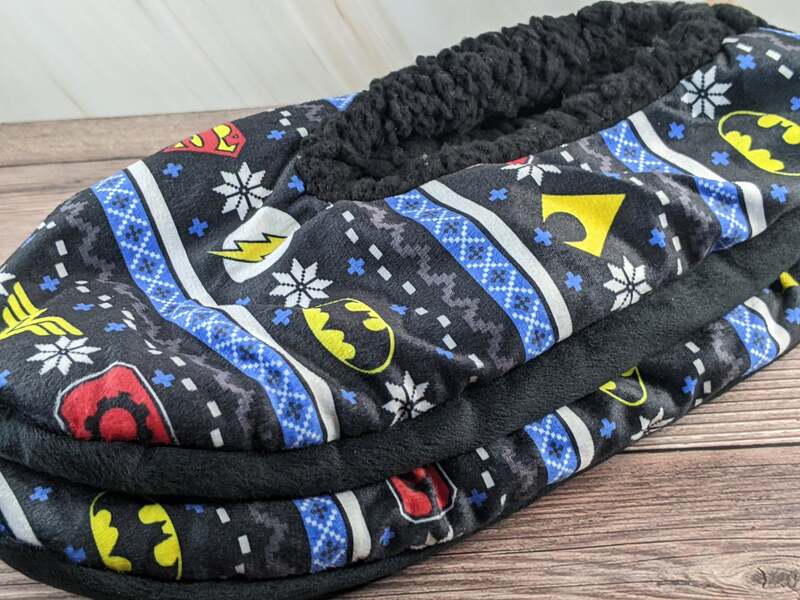 A pair of Christmas slippers for men, featuring the Justice League theme.