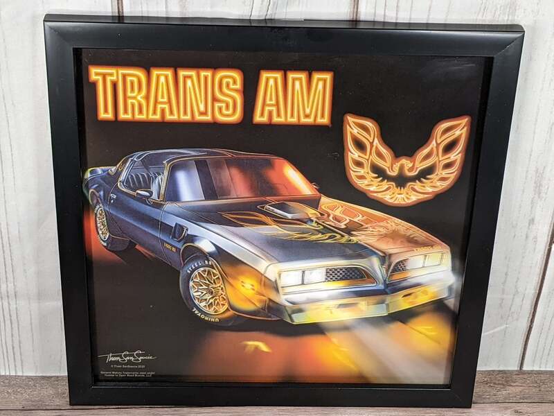 A wall art piece in a black frame that features vivid image-shifting effects of a Trans Am car made by GM.